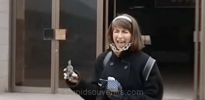 Tourist is oddly overjoyed by her souvenir purchase.